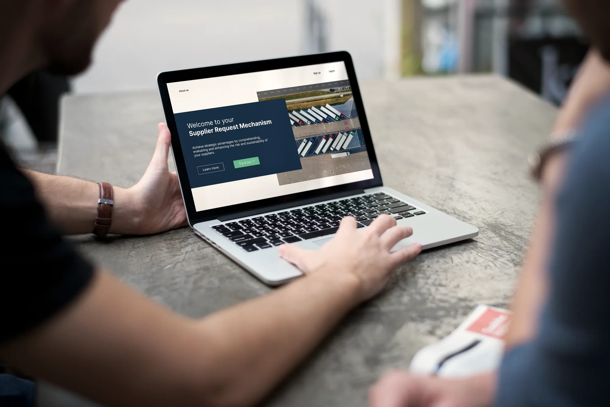 Hands on a laptop that shows a prototype web page